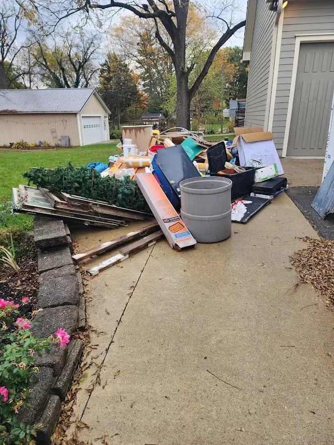 Dumpster being loaded with debris for 12 Yard Dumpster Rental in Danbury